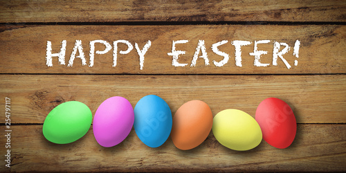 colored eggs with letters forming the word easter on wooden background