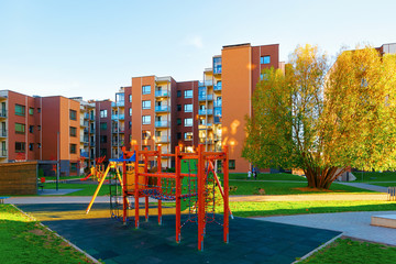 Fototapeta na wymiar Apartment residential house facade architecture with children playground