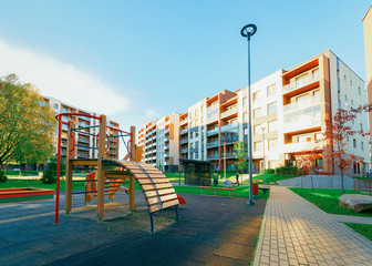 Apartment residential house facade architecture with child playground sun light