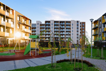 Apartment residential house facade architecture with children playground sun light