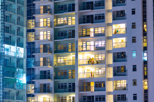 City apartment windows at night.  Residential highrise residences for metro housing in urban environment.