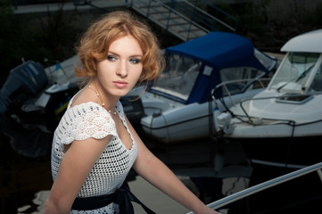 Fototapeta na wymiar Portrait of a girl in a white knitted dress