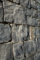 Background of a gray rock wall, square and rectangular blocks
