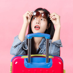 Traveler tourist woman in summer casual clothes.Asian Smiling woman wearing sun glasses.Passenger traveling abroad to travel on pink background.