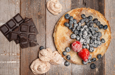 Healthy breakfast, homemade pancakes with fresh berries on wooden table