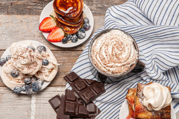 Healthy breakfast. Coffee and delicious pancakes, with fresh berries on wooden table