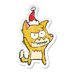 distressed sticker cartoon of a grinning fox wearing santa hat