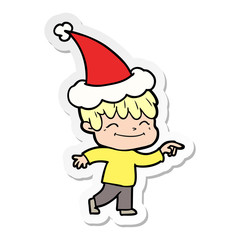 sticker cartoon of a happy boy wearing santa hat