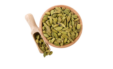 cardamon seeds  in wooden bowl and scoop isolated on white background. top view. Spices and food ingredients.