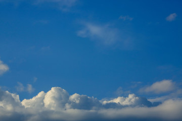 sunlight through fluffy white cloud on clear blue sky background
