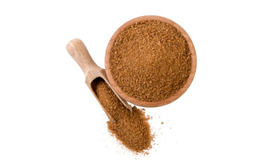 Brown or cane sugar  in wooden bowl and scoop isolated on white background. top view. Spices and food ingredients.
