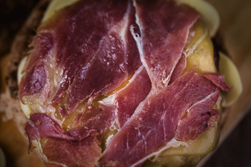 Burger with bacon, meat, tomato and lettuce on wooden background. Close up
