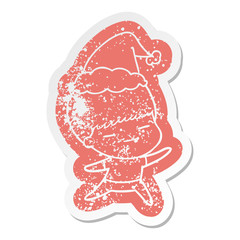 cartoon distressed sticker of a smug boy wearing santa hat