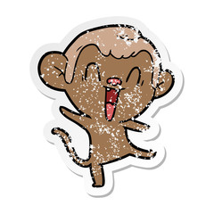 distressed sticker of a cartoon laughing monkey