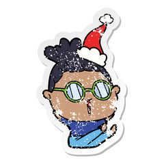 distressed sticker cartoon of a woman wearing spectacles wearing santa hat