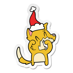 laughing fox sticker cartoon of a wearing santa hat