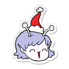 sticker cartoon of a alien space girl face wearing santa hat