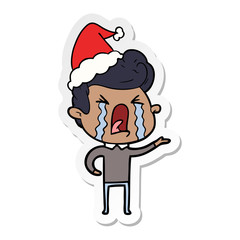 sticker cartoon of a crying man wearing santa hat
