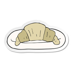 sticker of a cartoon croissant