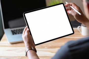 Man holding and using blank screen tablet