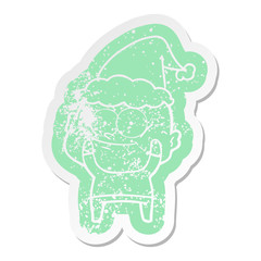 cartoon distressed sticker of a bald man staring wearing santa hat