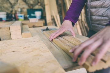 A woman works in a carpentry workshop.