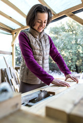 A woman works in a carpentry workshop.