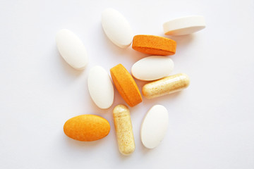 Colorful pharmaceutical medicine pills, tablets and capsules on white background