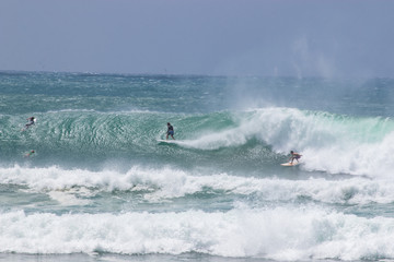 man surfer catching big wave from Kirra beach Coolangatta Queensland Gold Coast Australia cyclone swell