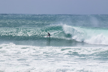 man surfer catching big wave from Kirra beach Coolangatta Queensland Gold Coast Australia cyclone swell