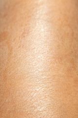 Fototapeta premium Woman's dry skin on leg, Close up & Macro shot, Asian skin tone, Abstract background