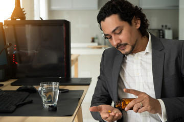 sick looking indian business male at office