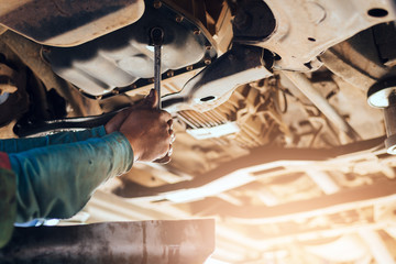 Concept Of car service and maintenance. Auto mechanic working in garage. Repair service.