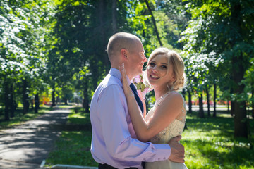 Fototapeta premium Russian bride and groom together in green city park
