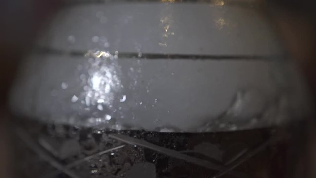 Air bubbles and smoke in water glass flask for smoking hookah in shiha bar. Close up glass flask with water and air bubbles for shisha smoking.