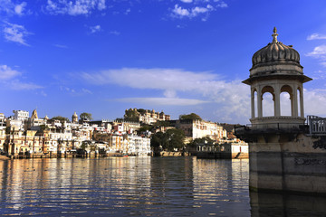 gazebo at lake Pichola with panoramic city view and reflection in Udaipur, Rajasthan, India