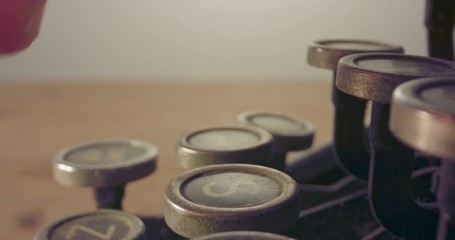 Special macro dolly shot hovering over old typewriter keys with male hand typing