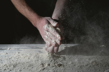 Man prepares a meal of flour