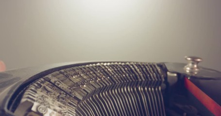 Special macro dolly shot hovering over old typewriter with male hand typing