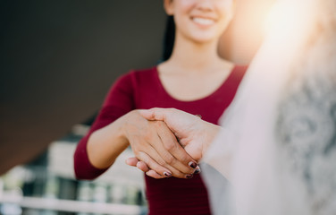 Negotiating business,Image of businesswomen Handshaking,happy with work,the woman she is enjoying with her workmate,Handshake Gesturing People Connection Deal Concept