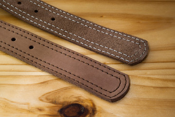 fashion leather belt  on wooden background  with steel metal buckle