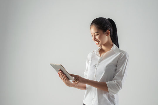 Attractive business woman working on tablet, concept of professional Business person.