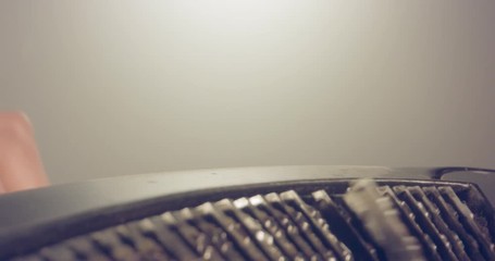 Special macro dolly shot hovering over old typewriter with male hand typing