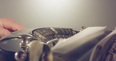 Special macro dolly shot hovering over old typewriter with male hand typing