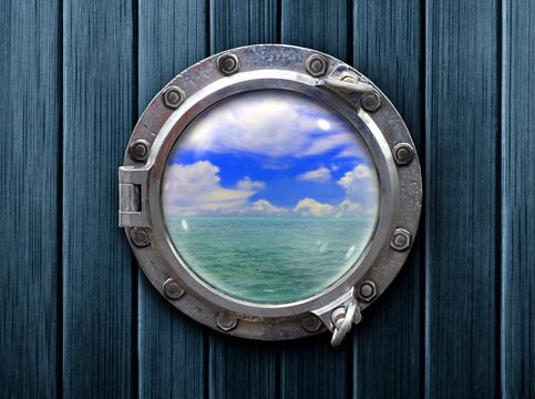Ship porthole with wooden wall and ocean view