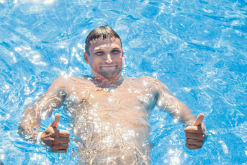 tanned man on vacation swimming in the pool