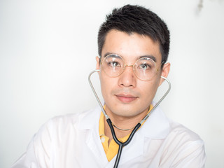 Portrait of handsome glasses asian doctor man with examining accessory