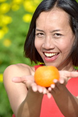 Smiling Attractive Diverse Female With An Orange
