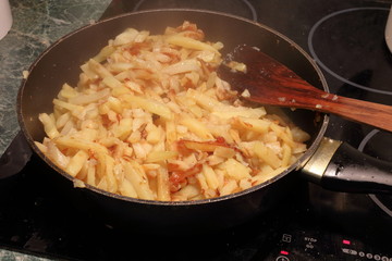 Fried potatoes in a saucepan.