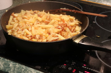 Fried potatoes in a saucepan.
